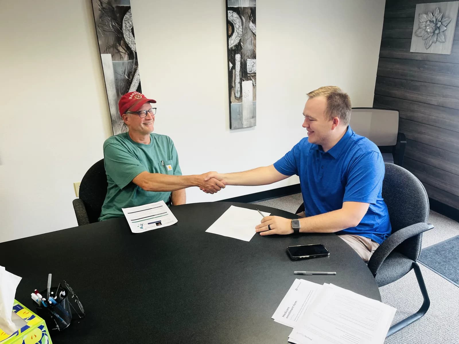 Hunter Klaassen helping a couple enroll in a Marketplace health plan at his Jackson, MI office