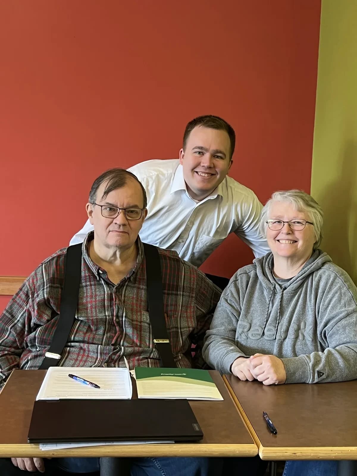 Hunter Klaassen helping a self-employed client choose a health plan at his Jackson, MI office