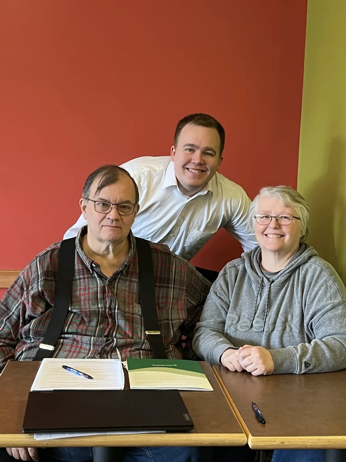 Hunter Klaassen meeting with a couple to review life insurance options at his Jackson, MI office